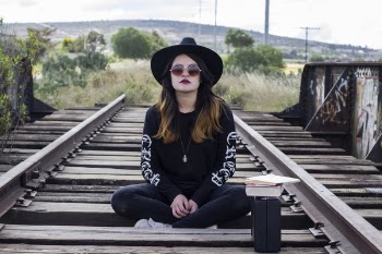 Woman Sitting on Railway