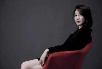 Woman Sitting on Red Armchair