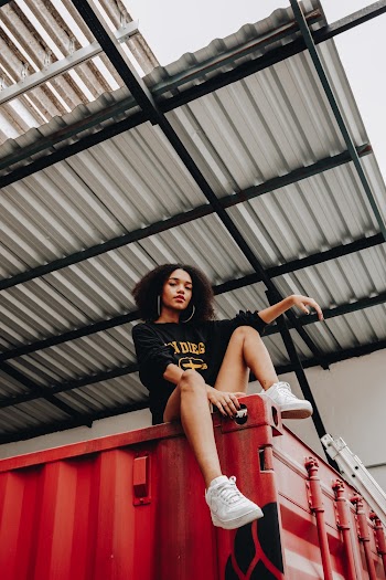 Woman Sitting On Red Container