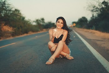 Woman Sitting on Road
