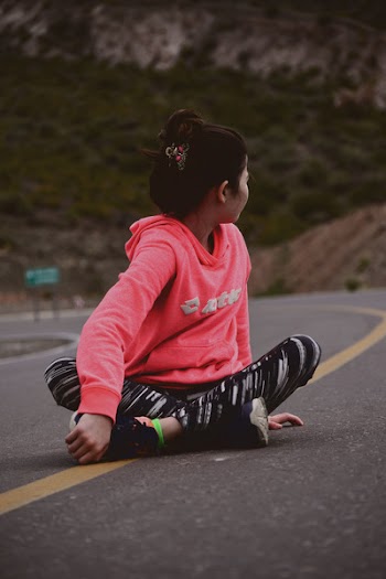 Woman Sitting on Road