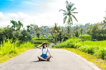 Woman Sitting on Road