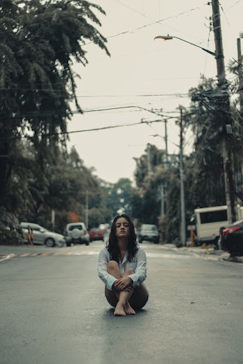 Woman Sitting on Road