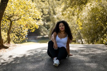 Woman Sitting on Road Under the Tree