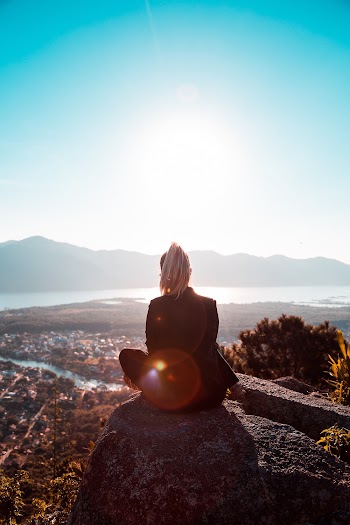 Woman Sitting On Rock