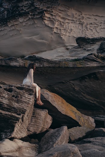 Woman Sitting on Rock