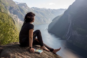 woman sitting on rock