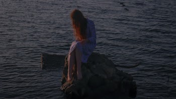 Woman Sitting on Rock