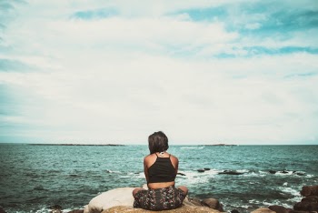 Woman Sitting On Rock 