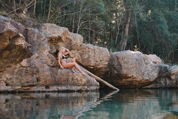 Woman Sitting on Rock