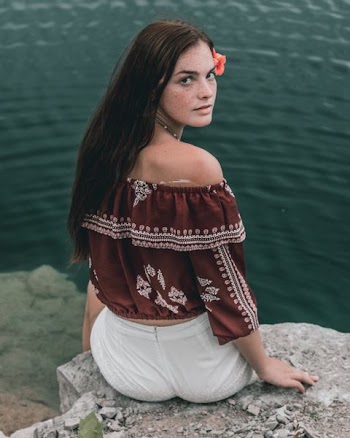 woman sitting on rock edge