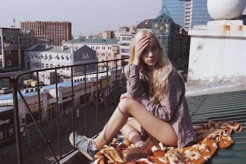Woman Sitting on Roof
