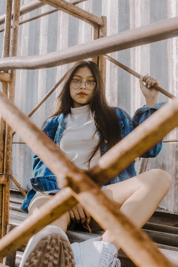 Woman Sitting on Scaffolding