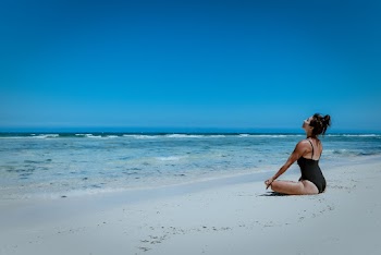 Woman Sitting on Seashore