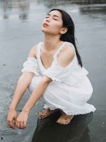 Woman Sitting on Seashore