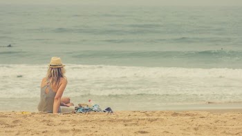 woman sitting on seashore