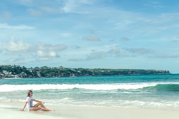 Woman Sitting on Seashore