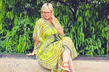 Woman Sitting on Side Pavement Wall Holding Her Ears