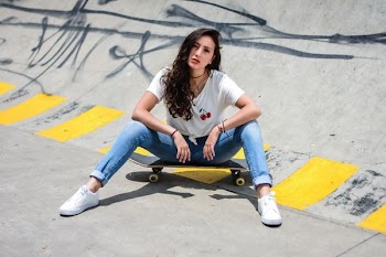 woman sitting on skateboard