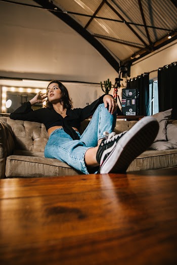 Woman Sitting On Sofa