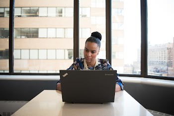 Woman Sitting on Sofa Facing Lenovo Thinkpad
