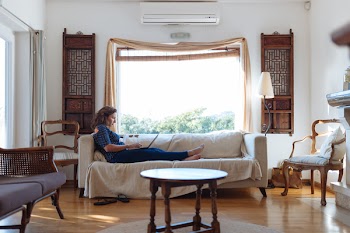 Woman Sitting on Sofa in Living Room