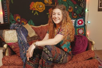 Woman Sitting On Sofa Smiling