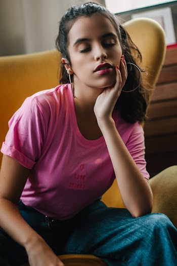 Woman Sitting on Sofa with Eyes Closed