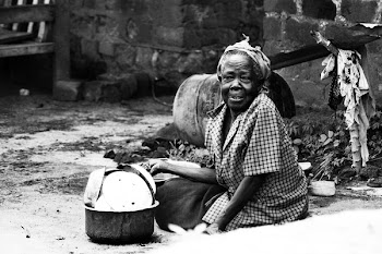 Woman Sitting on Soil Beside Cooking Pot