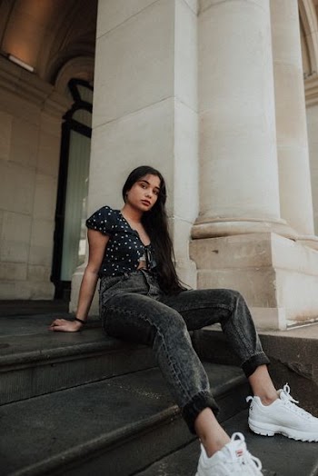 woman sitting on stairs during daytime