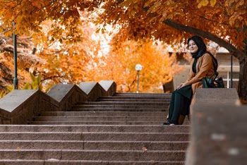Woman Sitting on Stairs Wall