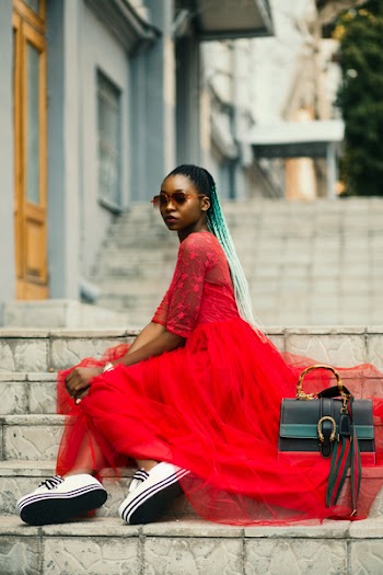 Woman Sitting on Stairway Wearing Sunglasses