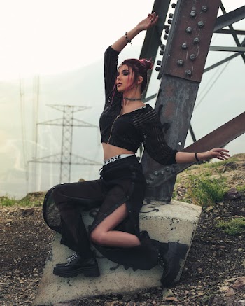 Woman Sitting On Steel Post 