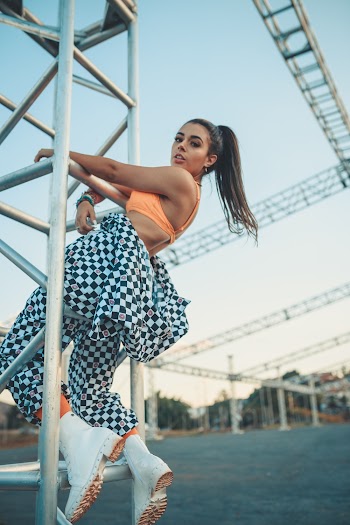 Woman Sitting on Steel Railing