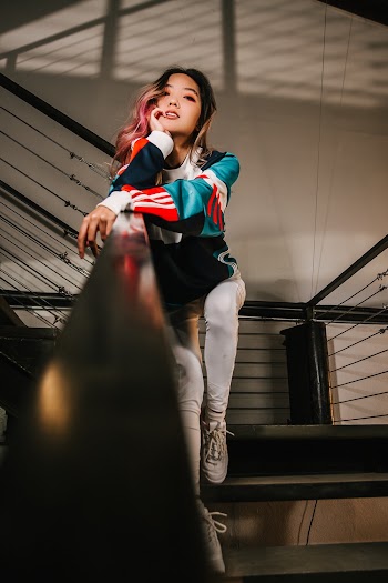 Woman Sitting On Steel Railing 