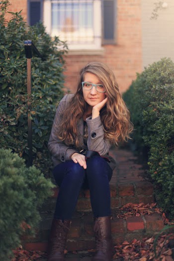Woman Sitting on Step in Between Bushes