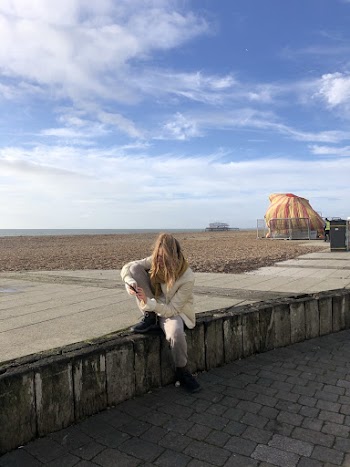 Woman Sitting on Stone Bench