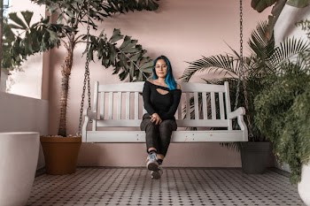 Woman Sitting On Swing Bench