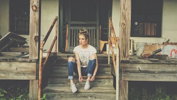 Woman Sitting on the Wooden Stair
