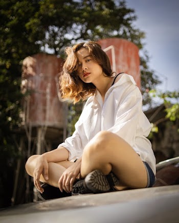 Woman Sitting On Top Of A Car