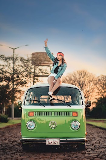 Woman Sitting on Top of Volkswagen 
