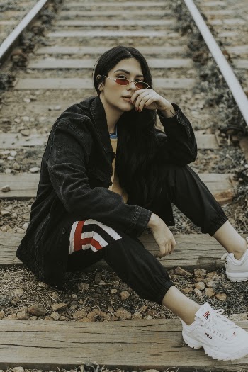Woman Sitting on Train Track