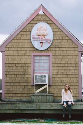 woman sitting on Tray's Ice Cream dock during daytime