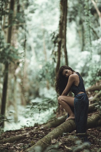 Woman Sitting on Tree's Root