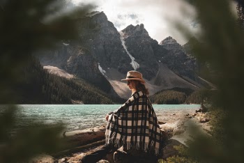 Woman Sitting on Tree Log