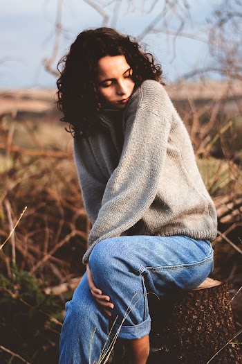 Woman Sitting on Tree Stump