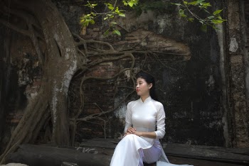 Woman Sitting on Tree Wearing White Long-sleeved Satin Dress