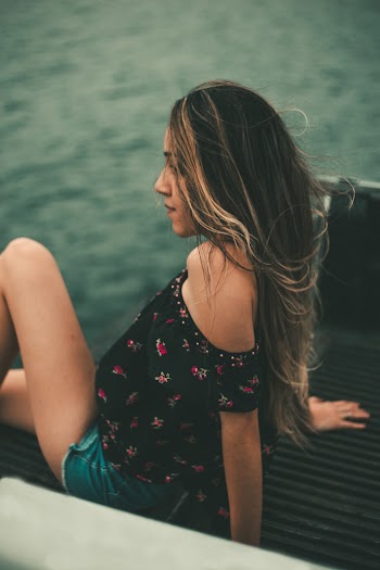 Woman Sitting On Truck Tailgate