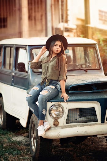 Woman Sitting on Vehicle on Selective Focus Photography