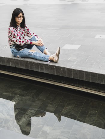 Woman Sitting on Water Fountain Bench